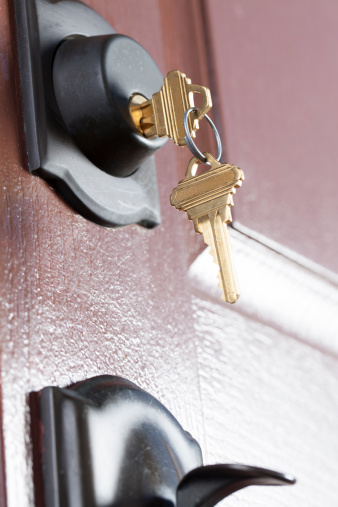 Keys in door of home