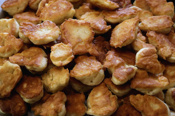 istock Fresh fried crispy fritter muffins. Many pancakes delicious background. 1749472655