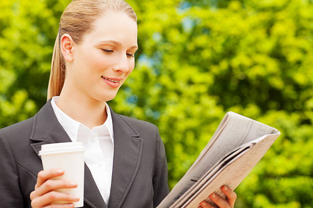 istock Female Executive Reading Newspaper 174947474