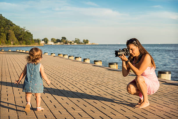 istock Young Mother Photographing Her Daughter 174947614