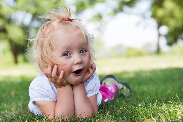 istock Little girl lying on grass 174948084