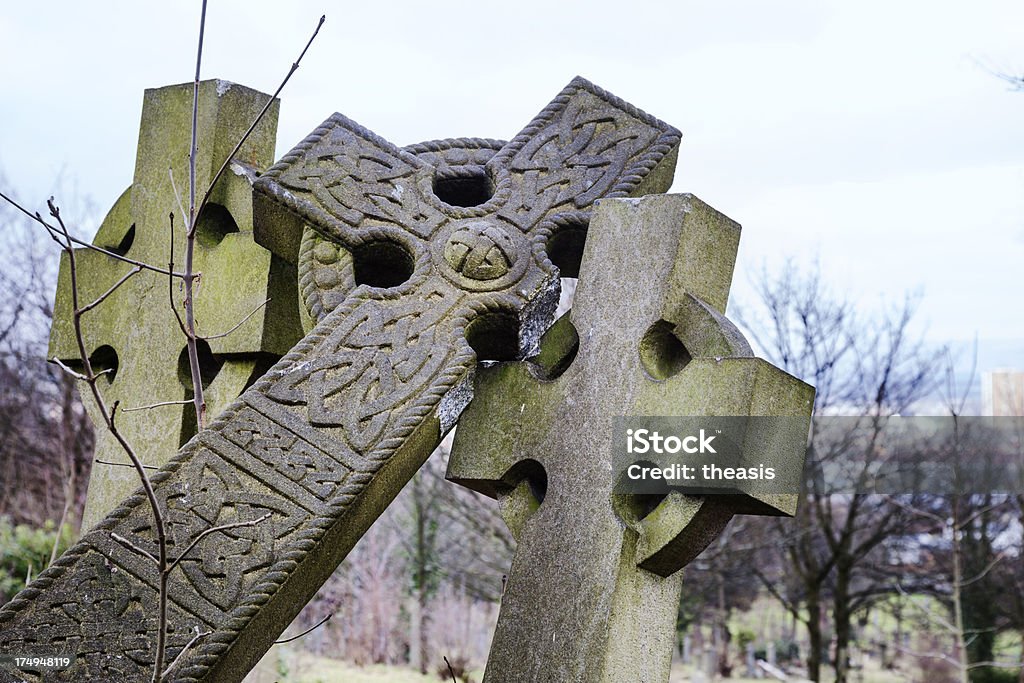 Broken Crosses Vandalised granite celtic cross gravestones in a dilapidated Glasgow cemetery. Broken Stock Photo