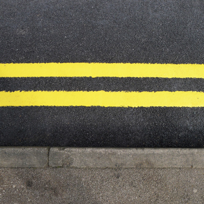 Close up of  freshly  Painted Double Yellow Lines