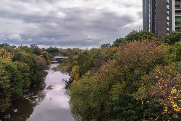 istock Small River or Creek in a Woodland area with a Residential Complex 1749483419
