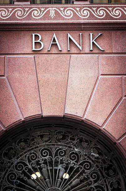 istock Bank sing on old building with window ornate security screen 174948525