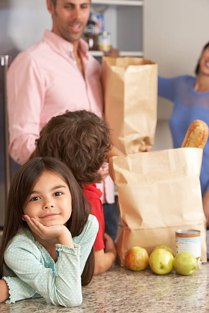 istock Family Unpacking Grocery Shopping In Kitchen 174948598
