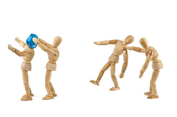 istock Wooden mannequins bullying another 174948767