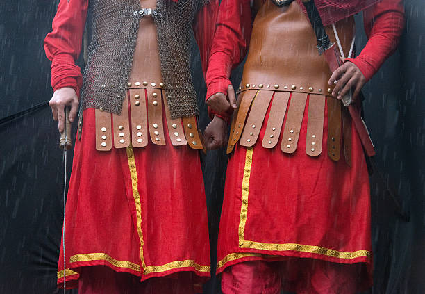 Two unrecognized soldiers wearing local cloths and holding their swords.