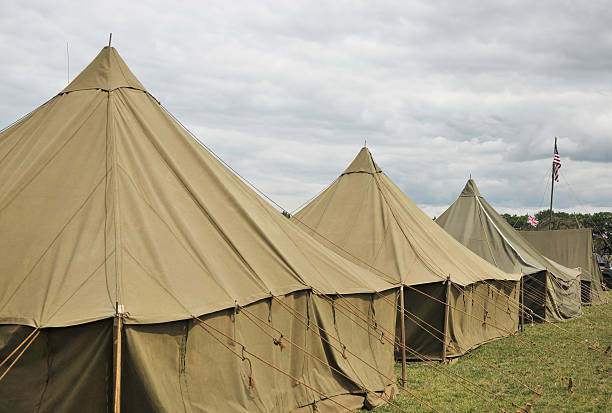 Army Tents Military tents in a row, as used by US forces during World War Two. military camp stock pictures, royalty-free photos & images