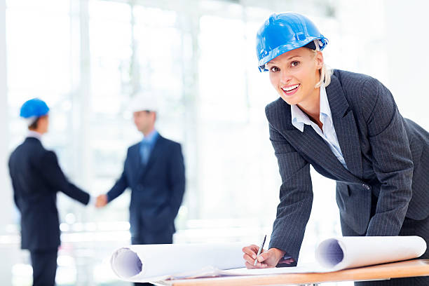 istock Happy Female Architect Working On Blueprint 174949251