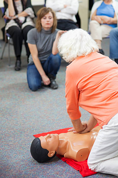 istock Senior Woman Practicing Chest Compressions 174949386