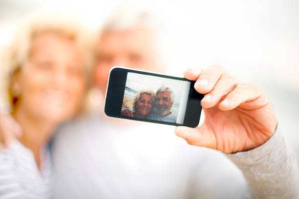 istock Smiling seniors taking photos 174949623