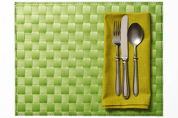 Isolated shot of green place setting on white background