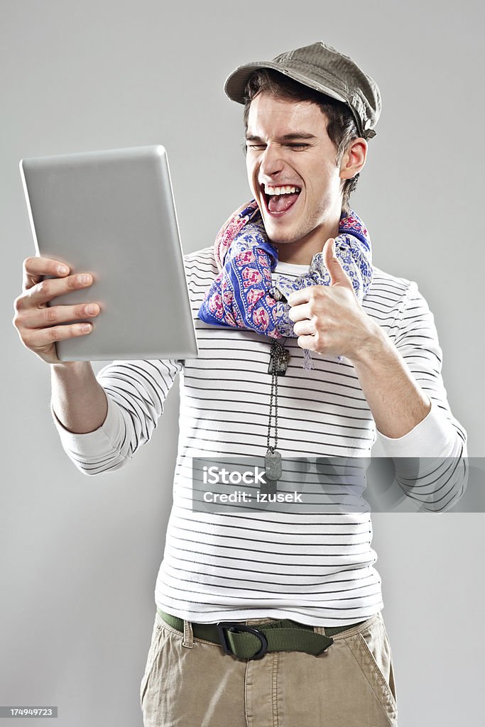Young man using digital tablet Happy young adult man taking self portrait using digital tablet. 20-24 Years Stock Photo