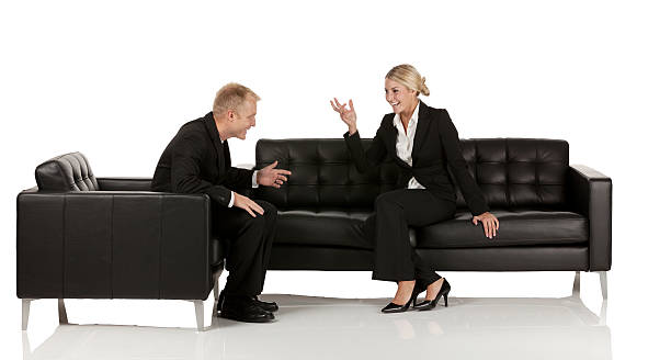 istock Happy business couple sitting on couch and talking 174949827