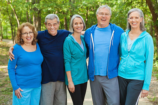 istock Healthy active seniors walking in park together 174950115