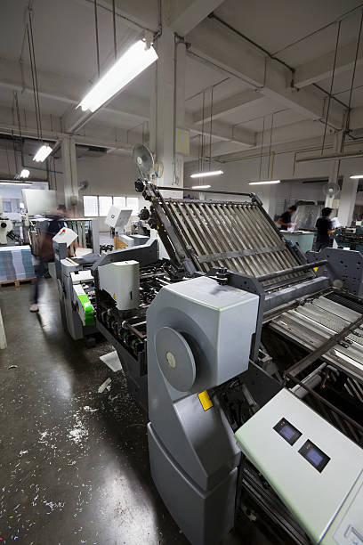 istock Paper signatures being folded at a printing factory. 174950378