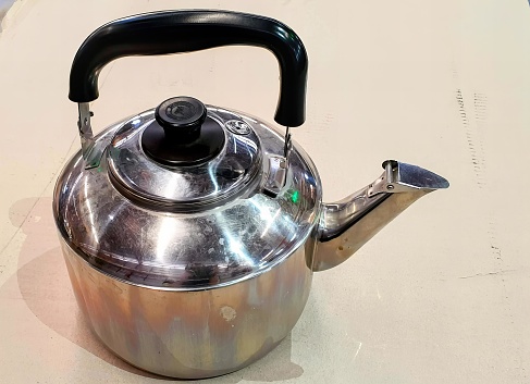 a teapot with a handle on a counter.