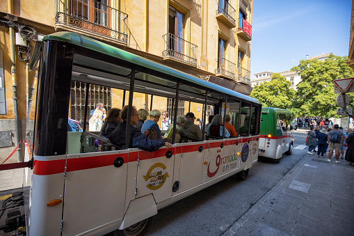 Granada city tour bus with tourists, Granada, Spain