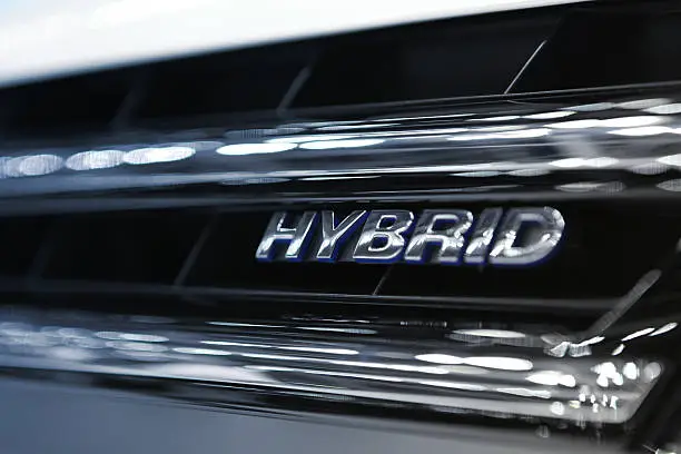Hybrid Word Written on car grill filtered to chrome and blue cold colors..Car Related Images..
