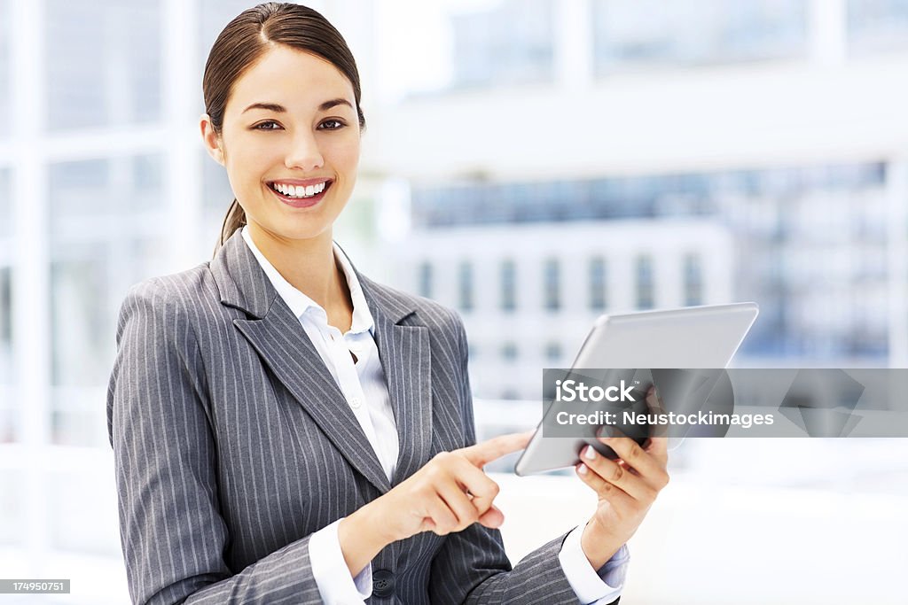 Businesswoman Using Digital Tablet Portrait of an attractive young businesswoman using digital tablet. Horizontal shot. 20-29 Years Stock Photo