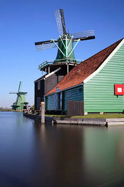 Photo of collection of historic windmills in a row at Zaanse Schans