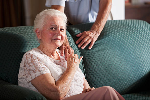istock Senior woman sitting on couch 174951948