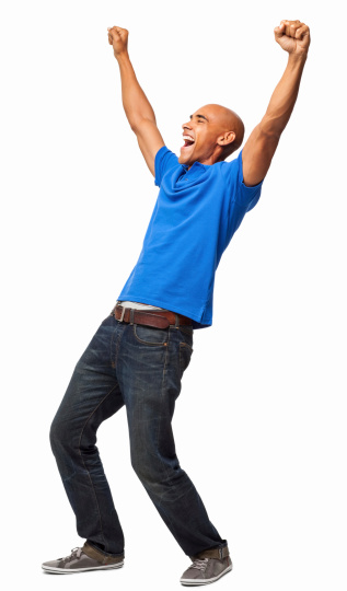 Full length of an excited young African American man in casuals cheering with arms up. Vertical shot. Isolated on white.
