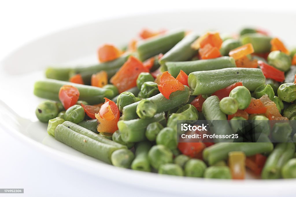 Vegan salad "Vegan salad.Ingredients: string beans, green peas, red bell pepper. Close-up." Green Bean Stock Photo
