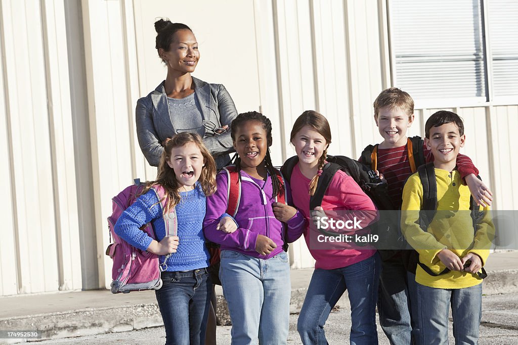 Insegnante con un gruppo di ragazzi della scuola elementare - Foto stock royalty-free di 6-7 anni