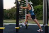 sporty woman stretching outdoors