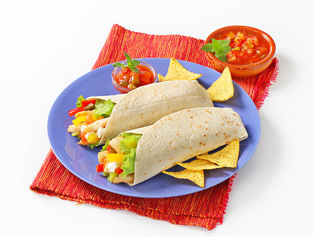 istock mexican fajitas (tortilla wraps) on a blue plate 174952635