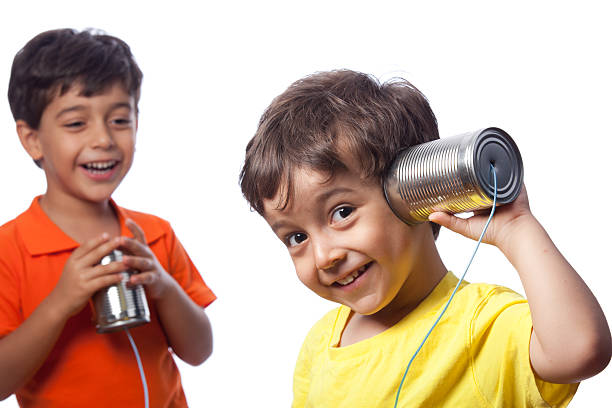 istock Little Boys Communicating Via Can Phone 174953193