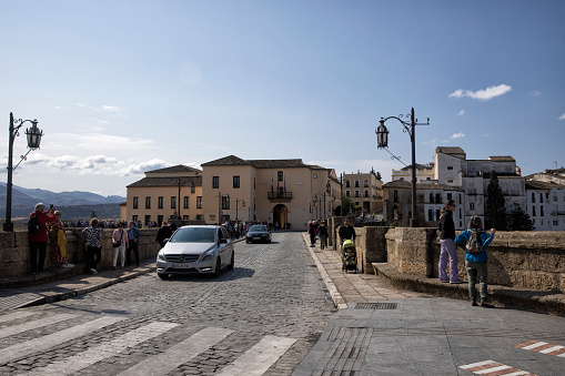 Puente Nuevo Bridge, Ronda, Spain. Tourists and cars can be seen crossing.
