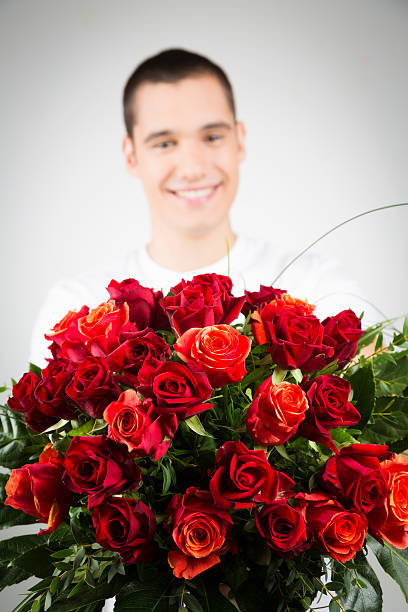 istock man holding bouquet of roses 174953294