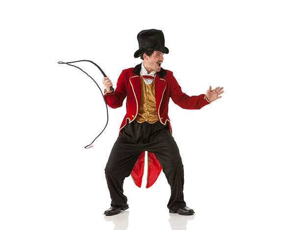Ringmaster performing with a whip Ringmaster performing with a whip tail coat photos stock pictures, royalty-free photos & images