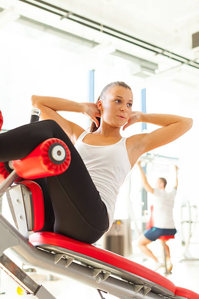 istock Woman Doing Sit Ups in the Gym 174954111