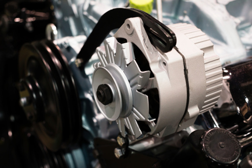 Photo of a car alternator on an engine. Picture is high resolution.