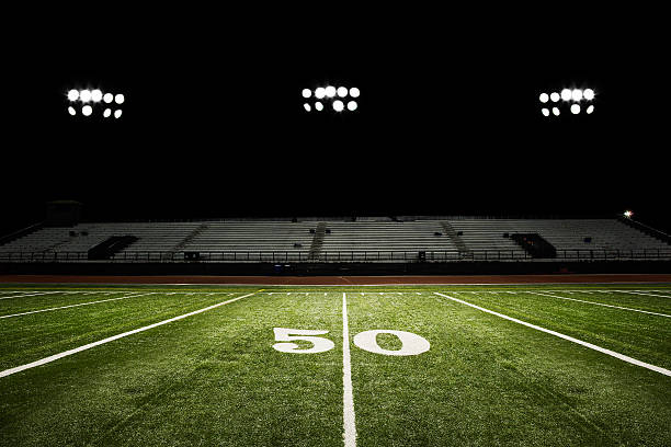 Football Field at Night  football field night american culture empty stock pictures, royalty-free photos & images
