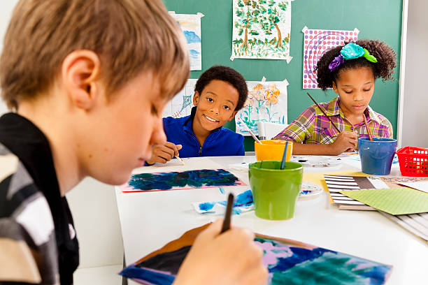 istock Multi-ethnic students in art class. Painting with watercolors 174954382