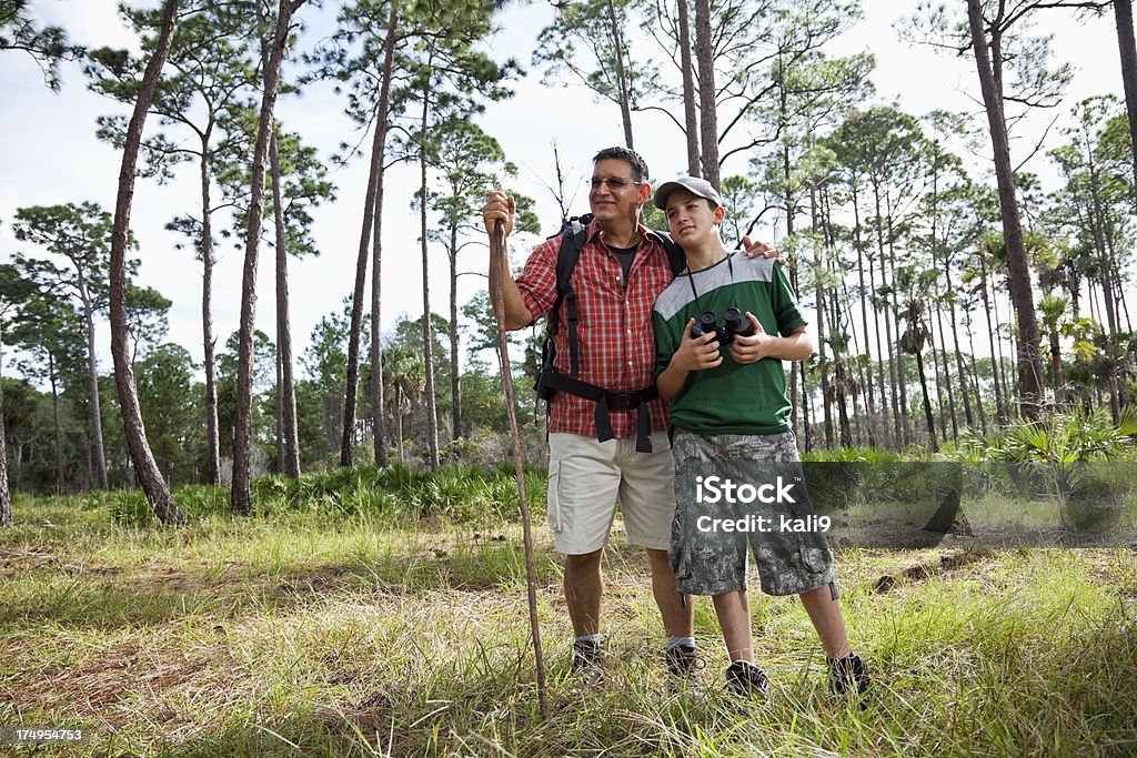 Hispanic father and son hiking. Hispanic father (40s) and son (10 years) hiking. Hiking Stock Photo