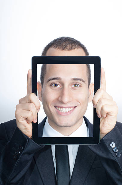 istock Young Businessman With His Face in a Digital Tablet 174954944