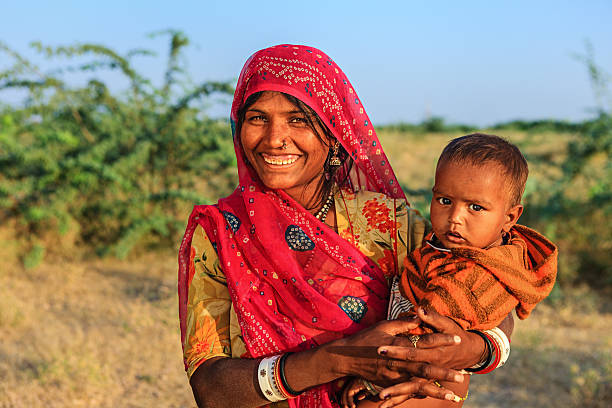 istock Young Indian woman holding her child 174955098