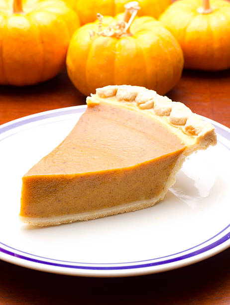 istock Slice of pumpkin pie with mine pumpkins 174955534