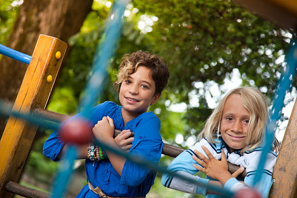 Happy childrens play in playground garden.