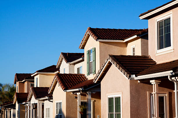 istock Neighborhood Stucco Home Exterior and Sky 174956304
