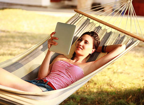 istock reading e-book in the sunny outdoors 174956459
