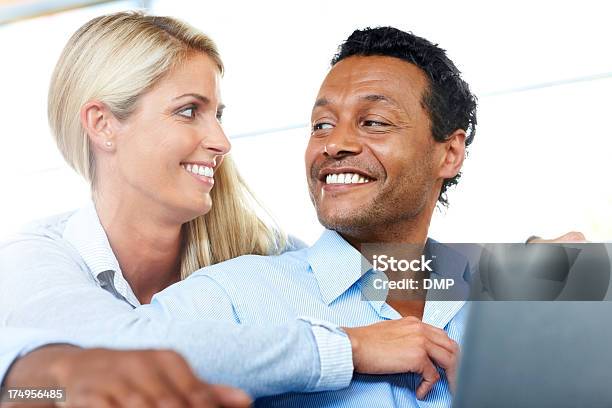 Beautiful Couple Smiling With Laptop Stock Photo - Download Image Now - Blond Hair, Couple - Relationship, Multiracial Group