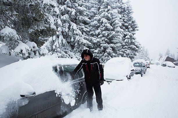 istock Senior man removing snow from his car 174956584
