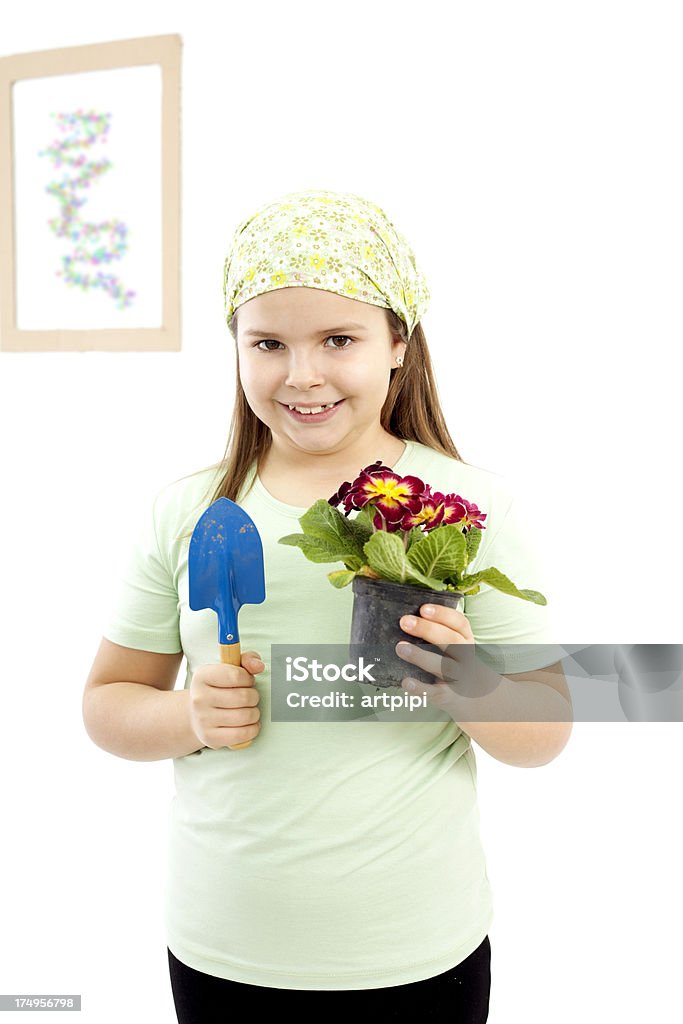 little gardener cute girl holding shovel and flower pot 10-11 Years Stock Photo